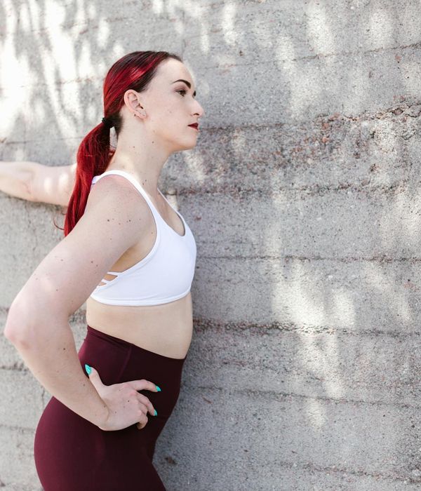 Person feeling energized and stretching outdoors during sunrise.