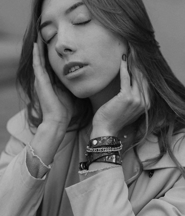 Woman in a calm yoga pose in a studio with warm ambient light.